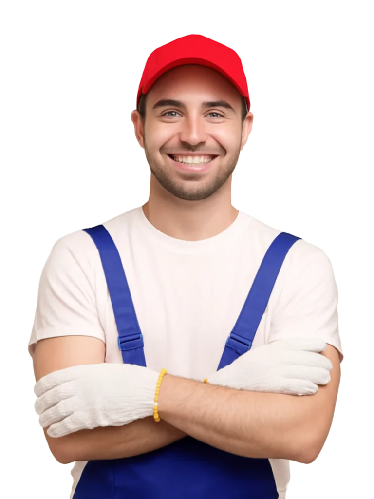 Hombre sonriente con gorra roja y overol azul, brazos cruzados